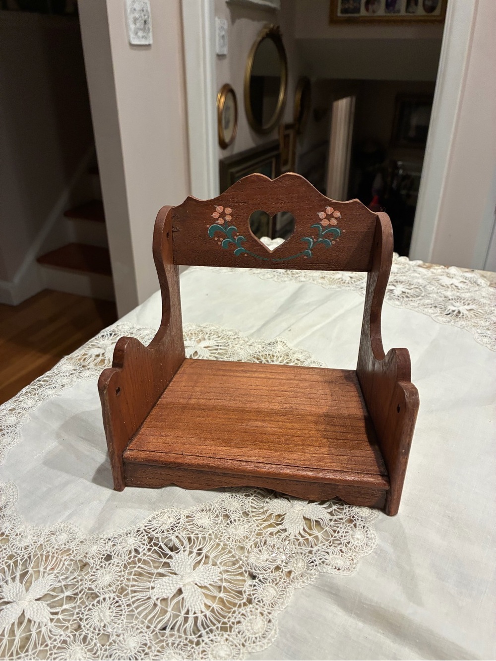Vintage wooden doll bench features heart-shaped cutout flowers accent